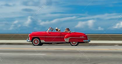HAVANA, CUBA - OCTOBER 20, 2017: Moving Old Car in Malecon, Havana. Cuba. Sightseeing Tour with Tourist