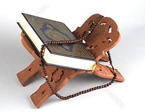 Holy Islamic book Koran Quran closed with rosary