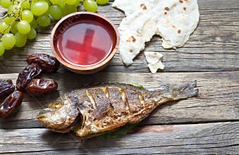 Easter food with fish passover bread cross in goblet of wine last supper abstract