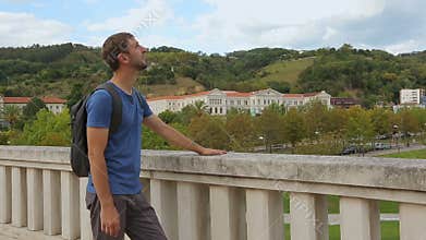 Young male tourist enjoying picturesque view and warm weather in Bilbao, Spain