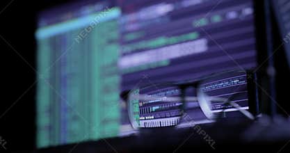 Cyber attack concept. glasses on the keyboard, on the background of the monitor