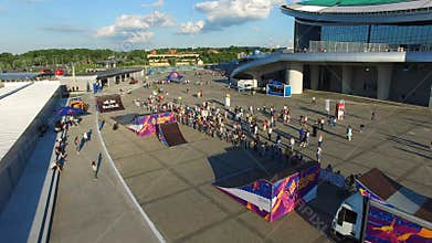 Camera Flies over Extreme Sports Show and People Riding Bikes