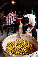 Families making traditional Chinese cakes or dumplings