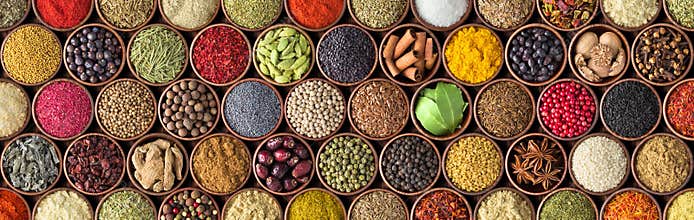 Different seasonings in cups. Spice background on the table