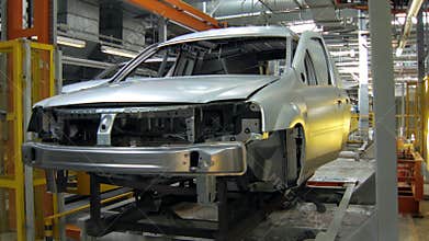 Automatic machines are transporting car bodies for construction and painting between departments