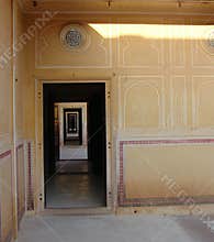 Locked in Home - A Long Corridor of Rectangular Doors with a Human Silhouette in Darkness