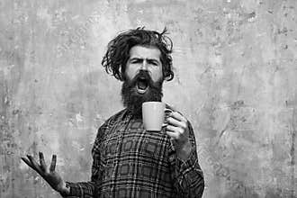 Morning coffe. singing bearded man pulling stylish fringe hair with blue cup
