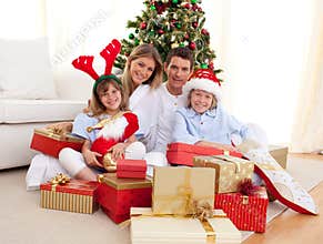 Happy family opening Christmas presents