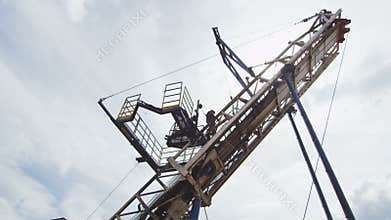 Courageous employee works on geodetic machine top