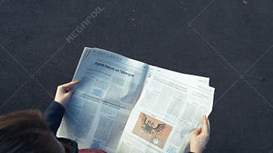 Woman reading newspaper politics in France and Germany