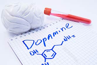 Neurotransmitter Dopamine in brain. Anatomic 3D brain model, lab test tube with blood and note, where is written title of dopamine