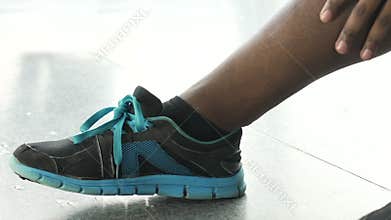 Multinational male massaging calf, overworked muscles after exercising, injury