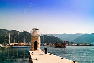 Marmaris marina with yachts and lighthouse.