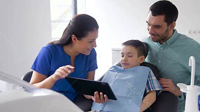 Dentist showing tablet pc to patient at clinic