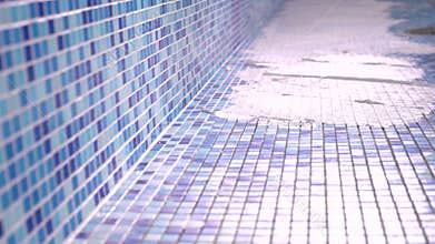 Male grouting newly installed ceramic tiles of swimming pool. construction of swimming pool.