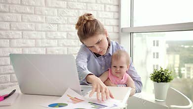 Baby distracted mother from conversation. Modern woman working from home