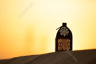 Traditional ornamental arabic candle in desert.