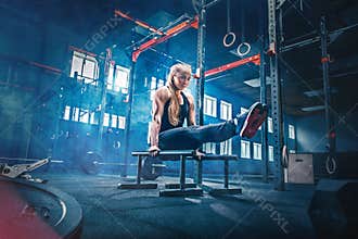 Concept: power, strength, healthy lifestyle, sport. Powerful attractive muscular woman at CrossFit gym