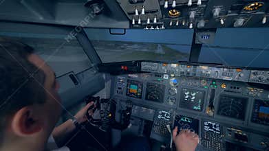 Two men are landing an aircraft in a flight simulation