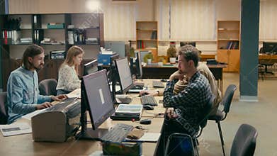 Young Employees are Working Together at their Computers in the Office