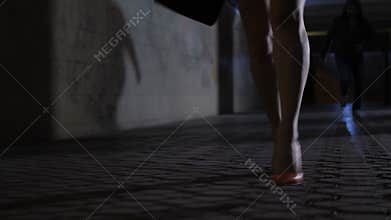 Close-up female legs running away from attacker