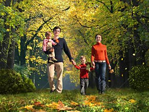 Walking family with children in autumnal park