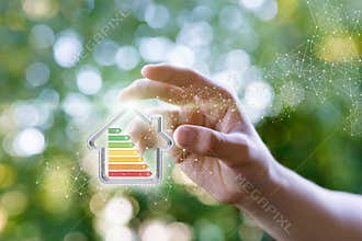 Hand shows a model energy efficient house.