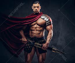 Brutal ancient Greek warrior with a muscular body in battle equipment posing on dark background.