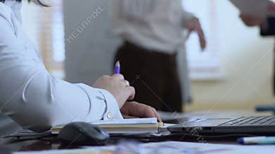 Woman secretary ready to write in notebook, waiting for instructions from boss