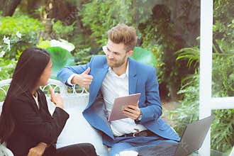Businesspeople using digital tablet computer working in modern office, business two people talking planning teamwork with laptop