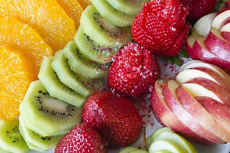 Strawberry kiwi apples and oranges are laid out for serving fest