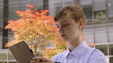 Woman with Clipboard Taking Notes