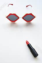 Close up of color lipsticks and sunglasses