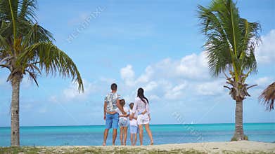 Family on the beach on caribbean vacation.