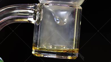 A cannabis diamond slowly melting on clear quartz