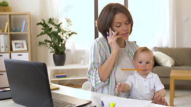 Working mother with baby calling on smartphone