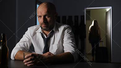 Woman with suitcase leaving husband after breakup