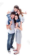 Jolly parents giving their children piggyback ride
