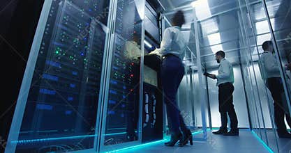 IT workers in glowing data center