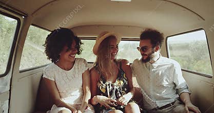 One blonde woman and one african young girl with curly hair wearing a vintage dresses , with their friend going on the