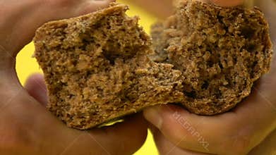 Male hands tearing black bread, poverty, begging, low social security, closeup