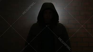 Serial killer in the dark breathing heavily waiting for the victim
