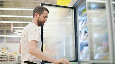 Casual guy buys food in store.