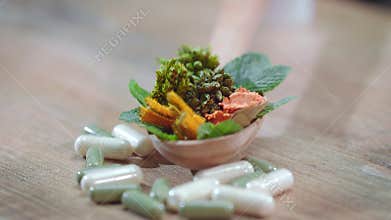 Herbal therapy concept. Medical herbs and pills. Herbal medicine capsules