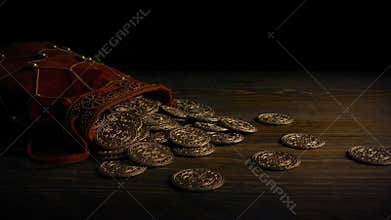 Passing bag of gold coins on table