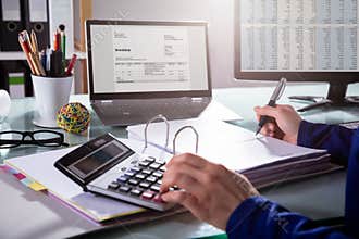 Businessperson Calculating Invoice