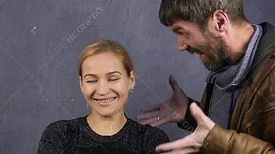 Family quarrel. domestic violence. husband yells at his wife. calm girl looks at the camera. slow motion