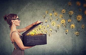 Side view of a woman with box full of brilliant ideas being creative