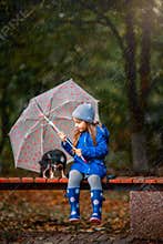 Girl with Chihuahua dog in autumn park