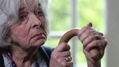 Sad Senior Woman With Walking Stick